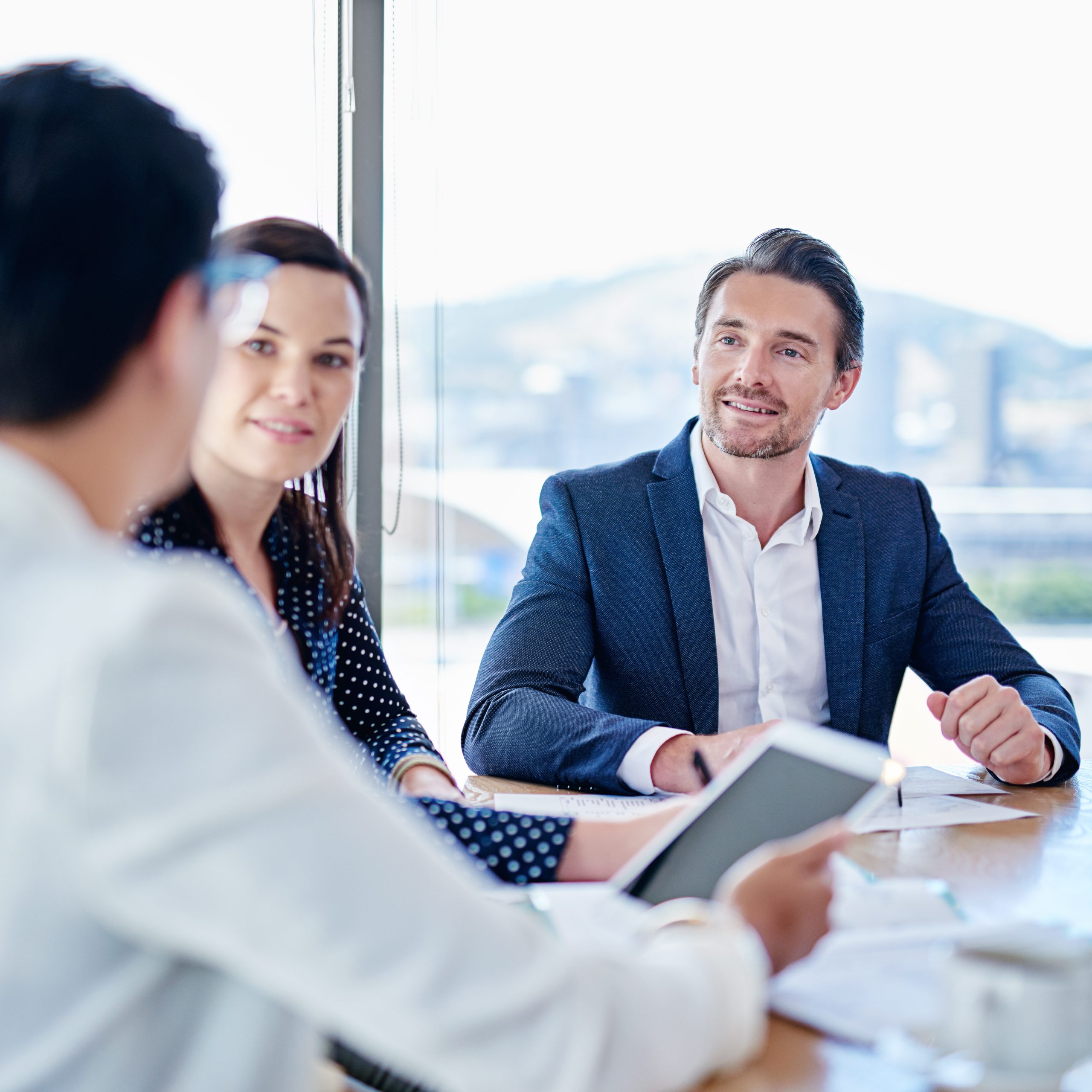People, tablet and meeting with paperwork, office and explaining to lobbyist, collaboration or planning. Business, talking and employees with documents, woman and man in boardroom or idea for project